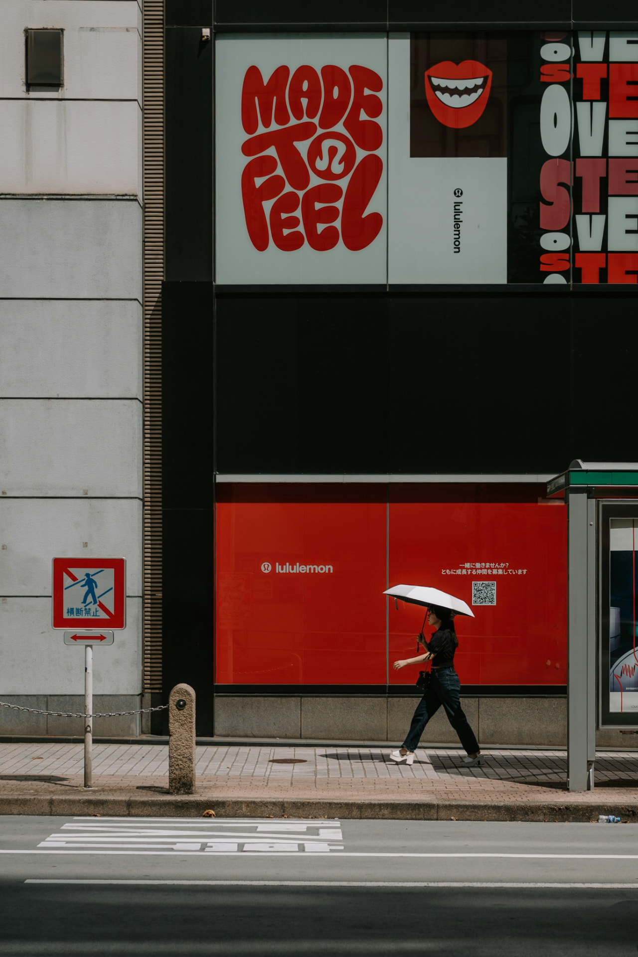 Bold red storefront branding and typography on a city street